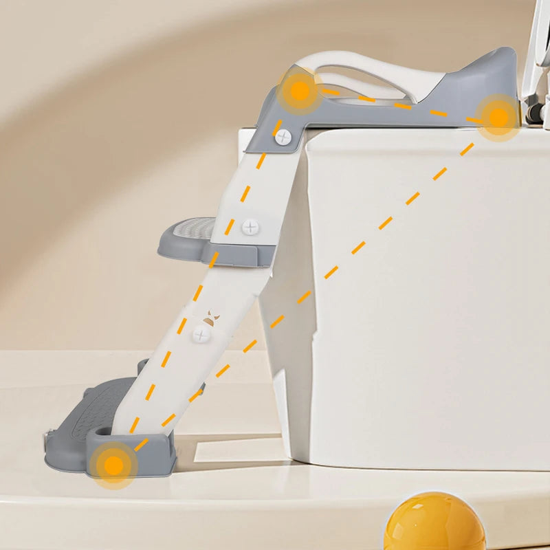 Toilet training seat with steps set up against a toilet